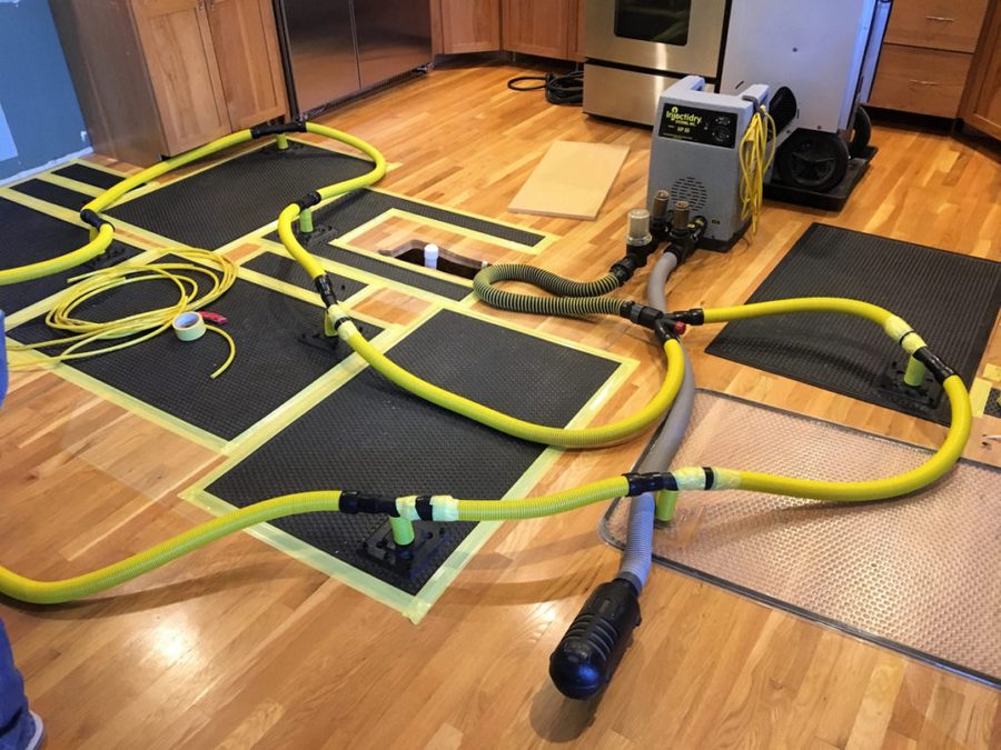 Floor drying equipment in use after water damage